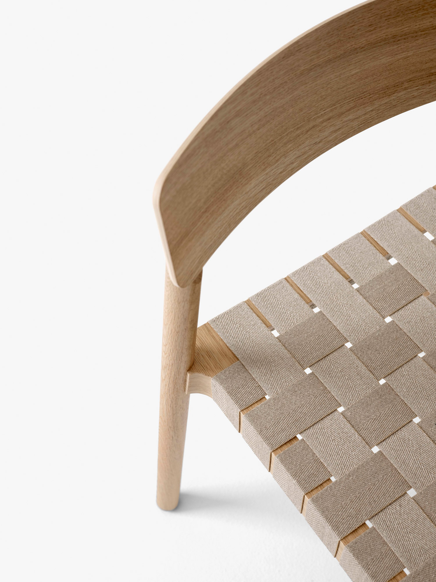 Detail shot of Oak Betty Chair with a seat made of exposed webbing by Thau & Kallio | Aesence