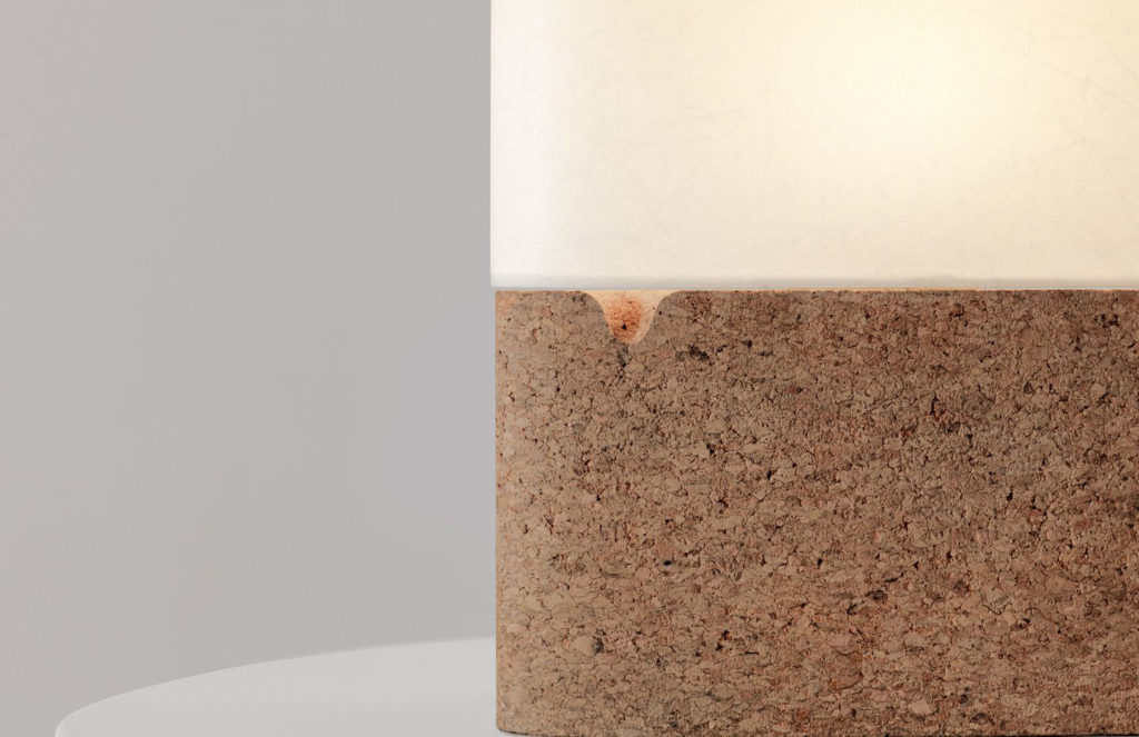 The base of the Fulcrum Table lamp is made of cork or sand-cast bronze