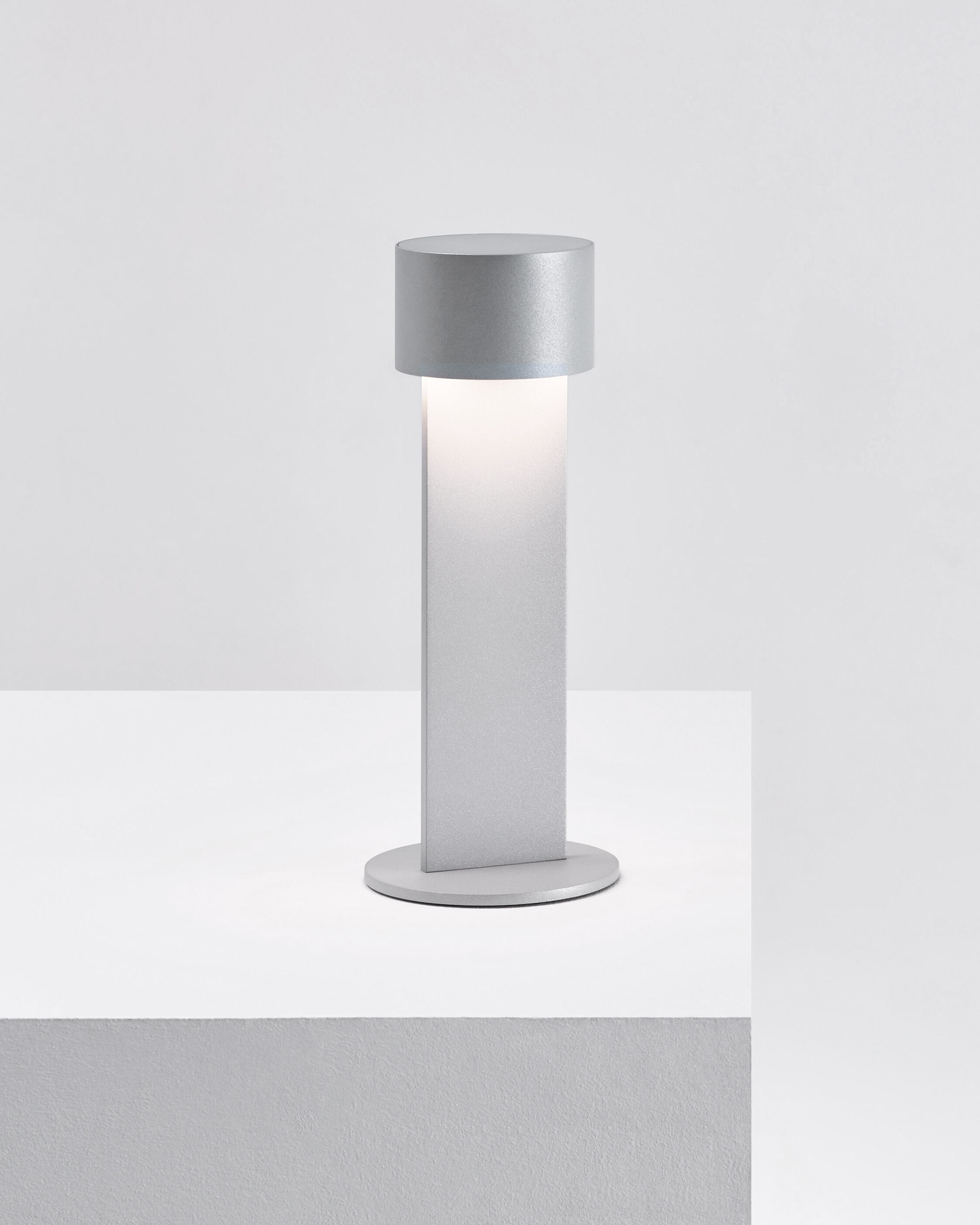 Grey Times Table Lamp by FROM LIGHTING standing on a podest | Aesence