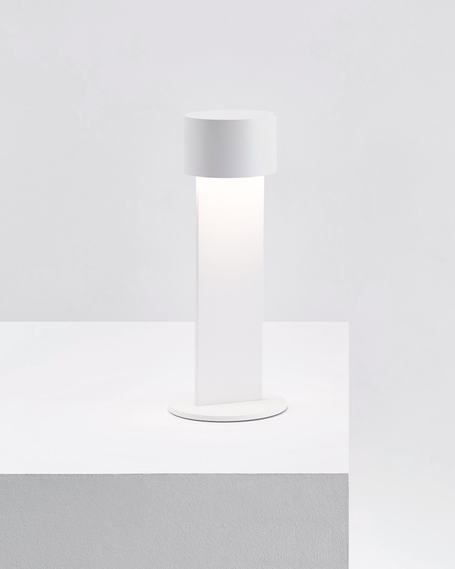 White Times Table Lamp by FROM LIGHTING standing on a podest | Aesence