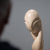 A man is looking at a version of “Mlle Pogany” by Constantin Brâncuși. Image from the exhibition “Constantin Brâncuși” at the Center Pompidou 2024 © Photography by Sarah Dorweiler / Aesence