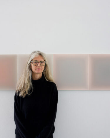 Gwen Hardie with a close-up of "Arc of the sun - Venetian red", 16 x 16 in, for UNTITLED, Miami Beach, Dec 3-7, 2025 with Arden and White © The Artist