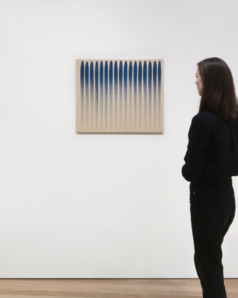 Melooking at an artwork by Lee Ufan, on view at 'Minimal' at Bourse de Commerce, Paris, 2025 © Photography by Aesence / Sarah Dorweiler